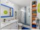 Modern bathroom features a sleek vanity, glass-enclosed shower with stylish tiles, and vibrant decor at 11 1St E St, Nokomis, FL 34275