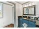 Modern bathroom with a gray vanity, granite countertop, framed mirror and views through the bright window at 11 1St E St, Nokomis, FL 34275