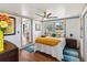 Well-lit bedroom with ceiling fan, wood floors, and a window overlooking the front yard at 11 1St E St, Nokomis, FL 34275