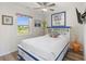 Bright bedroom with a cozy bed frame, stylish furnishings, and lots of natural light at 11 1St E St, Nokomis, FL 34275