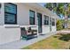 Charming home exterior with seating area, fresh paint, and landscaping at 11 1St E St, Nokomis, FL 34275