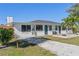 Well-maintained home exterior with modern accents and a beautifully landscaped yard at 11 1St E St, Nokomis, FL 34275