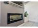 Sleek fireplace design features a glass front, ambient lighting, and built-in shelving at 11 1St E St, Nokomis, FL 34275
