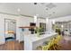 Bright, open kitchen featuring a large marble island with seating and modern appliances at 11 1St E St, Nokomis, FL 34275