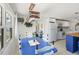 Bright, open-concept kitchen and dining space featuring white cabinets and modern appliances and a beautiful dining set at 11 1St E St, Nokomis, FL 34275