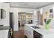 Bright, open kitchen featuring a large marble island and stainless appliances and tile floors at 11 1St E St, Nokomis, FL 34275