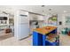 Well-lit kitchen with a view of the seating area, stainless steel appliances, white cabinets, and butcherblock island at 11 1St E St, Nokomis, FL 34275