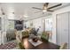 Open-concept living room and dining area features contemporary furnishings, modern lighting, and a stylish fireplace at 11 1St E St, Nokomis, FL 34275