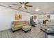 Bright living room with tile floors, comfortable seating, and seamless flow to the dining area at 11 1St E St, Nokomis, FL 34275