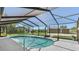 Screened-in pool with clear blue water, patio area, and view of the backyard at 11 1St E St, Nokomis, FL 34275