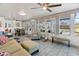 Bright sunroom with tile floors, multiple windows overlooking the pool and backyard, and comfortable seating at 11 1St E St, Nokomis, FL 34275