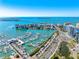 Breathtaking aerial view of a marina filled with boats and yachts near waterfront condos on a sunny day at 1155 N Gulfstream Ave # 508, Sarasota, FL 34236