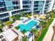 Aerial view of pools, hot tub, and sun loungers in community at 1155 N Gulfstream Ave # 508, Sarasota, FL 34236