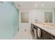 Modern bathroom with dual sinks, marble countertops, and a glass-enclosed shower at 1155 N Gulfstream Ave # 508, Sarasota, FL 34236