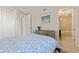 Bedroom view with dresser and open door to a well-lit, tiled bathroom at 1155 N Gulfstream Ave # 508, Sarasota, FL 34236