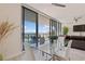 Open-concept dining room featuring a glass table, modern decor, and stunning waterfront views at 1155 N Gulfstream Ave # 508, Sarasota, FL 34236