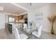 Bright dining area adjacent to the kitchen with a glass dining table at 1155 N Gulfstream Ave # 508, Sarasota, FL 34236