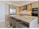 Bright kitchen with stainless steel appliances and an island breakfast bar at 1155 N Gulfstream Ave # 508, Sarasota, FL 34236