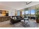 Stylish living room with a sectional sofa, an open kitchen, and a sliding glass door to the balcony at 1155 N Gulfstream Ave # 508, Sarasota, FL 34236