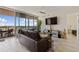 Bright living room with floor-to-ceiling windows, a comfortable leather sofa, and views of the harbor at 1155 N Gulfstream Ave # 508, Sarasota, FL 34236