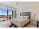 Comfortable bedroom with a tufted headboard, modern decor, and beautiful views of the harbor at 1155 N Gulfstream Ave # 508, Sarasota, FL 34236