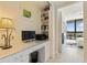 Bright office with a built-in desk, ample storage, and a view into the main bedroom at 1155 N Gulfstream Ave # 508, Sarasota, FL 34236