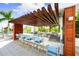 Outdoor kitchen with grill, counter seating, and pergola at 1155 N Gulfstream Ave # 508, Sarasota, FL 34236