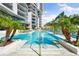 Beautiful pool surrounded by lush landscaping and palm trees, with lounge chairs at 1155 N Gulfstream Ave # 508, Sarasota, FL 34236