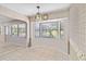 Breakfast nook with a bay window, a decorative light fixture, and views to the living room at 125 Golf Club Ln, Venice, FL 34293