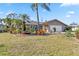 Charming single-story home featuring lush landscaping and a well-maintained lawn at 125 Golf Club Ln, Venice, FL 34293