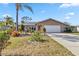 Well maintained house with a beautiful lawn and two car garage at 125 Golf Club Ln, Venice, FL 34293