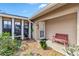 Inviting front entrance featuring a cozy bench and well maintained landscaping at 125 Golf Club Ln, Venice, FL 34293