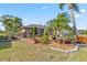 Lush landscaping surrounds this home, complete with rock borders and beautiful plants at 125 Golf Club Ln, Venice, FL 34293