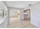 Light-filled living space showcasing light hardwood floors and an open archway to the breakfast nook at 125 Golf Club Ln, Venice, FL 34293