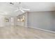 Bright, airy living space with an open layout, light wood-look floors, and views into the kitchen at 125 Golf Club Ln, Venice, FL 34293