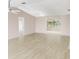 Spacious living room with light hardwood floors and neutral paint, great for entertaining or relaxing at 125 Golf Club Ln, Venice, FL 34293