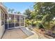 Covered and screened lanai featuring beautiful views of the private backyard and landscaping at 125 Golf Club Ln, Venice, FL 34293
