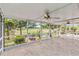 Relaxing screened patio with ceiling fans that overlooks lush landscaping and serene golf course views at 125 Golf Club Ln, Venice, FL 34293