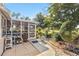 View of a covered patio leading to a lush backyard with a pathway and mature trees at 125 Golf Club Ln, Venice, FL 34293