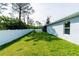 Lush backyard with a white fence, providing a private and green outdoor space at 13339 Flaherty Ave, Port Charlotte, FL 33981