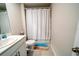 Simple bathroom with a white vanity, toilet, and shower with curtain at 13339 Flaherty Ave, Port Charlotte, FL 33981