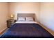 Comfortable bedroom with a queen bed, neutral walls, and a side table with lamp at 13339 Flaherty Ave, Port Charlotte, FL 33981