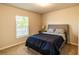 Cozy bedroom with a comfortable bed, soft carpet, and a bright window view at 13339 Flaherty Ave, Port Charlotte, FL 33981