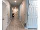 Long hallway featuring tile floors and white doors, creating a clean and spacious feel at 13339 Flaherty Ave, Port Charlotte, FL 33981