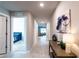 Hallway with neutral paint, hard surface flooring, accent furniture, and a glimpse into the bedroom at 13339 Flaherty Ave, Port Charlotte, FL 33981