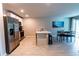 Modern kitchen featuring stainless steel appliances, bright white cabinets, and a dining area at 13339 Flaherty Ave, Port Charlotte, FL 33981