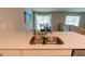 Kitchen featuring a breakfast bar with stainless steel dual sinks and a modern pull-down faucet at 13339 Flaherty Ave, Port Charlotte, FL 33981