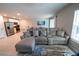 Open-concept living room with a sectional sofa, view into kitchen, and bright, neutral decor at 13339 Flaherty Ave, Port Charlotte, FL 33981