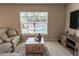 Comfortable living room with a sectional sofa, wooden coffee table, TV, and access to pool at 13339 Flaherty Ave, Port Charlotte, FL 33981