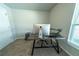 Bright office featuring a modern desk, large monitor, and a window for natural light at 13339 Flaherty Ave, Port Charlotte, FL 33981